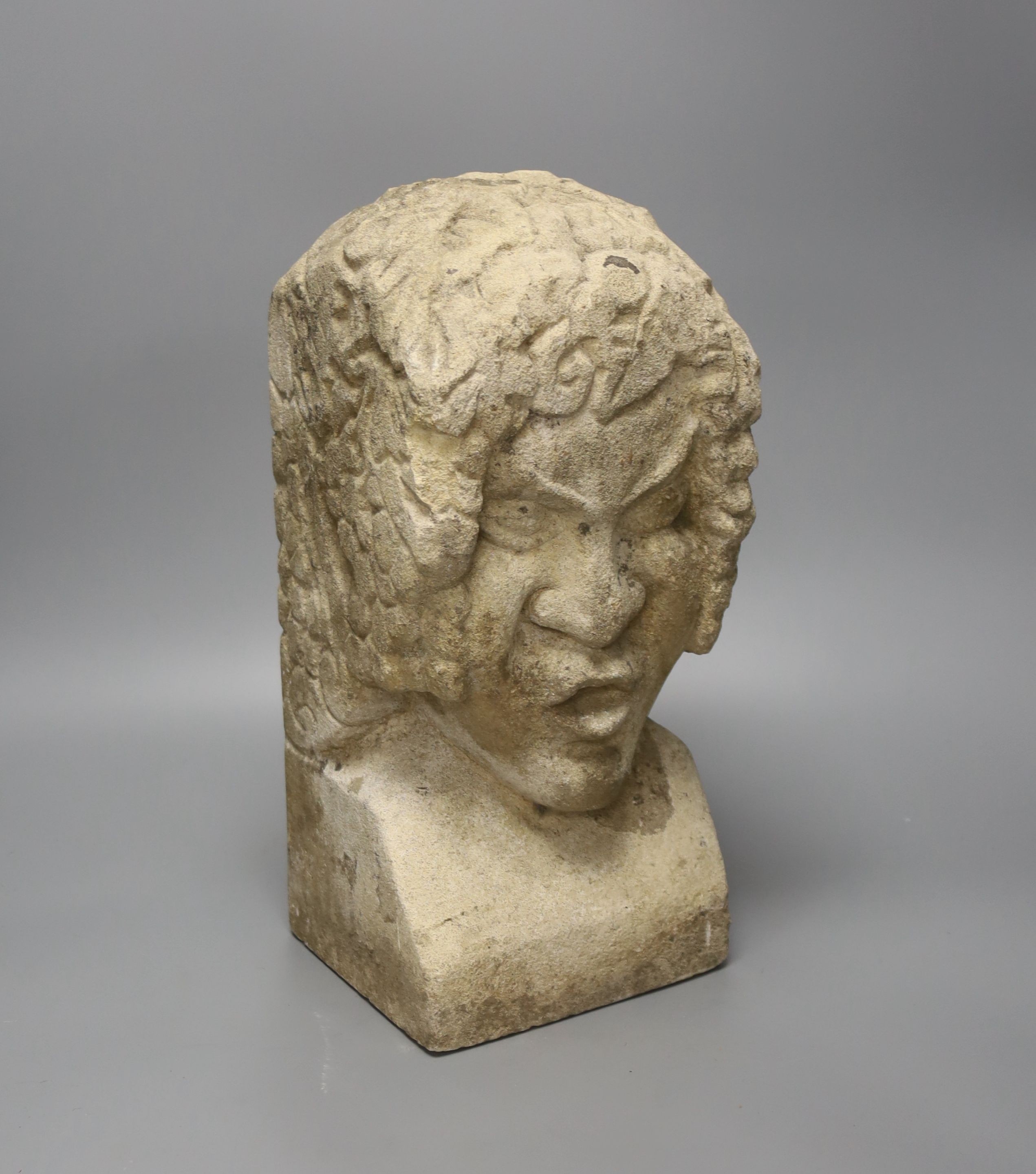 A carved sandstone grotesque bust, stonemason’s mark to back, 36cm